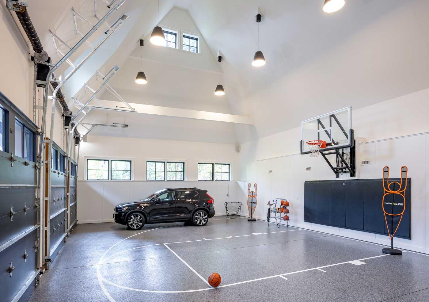 Shingle style home in rural wooded setting - 林奇建设 indoor basketball court and 3 car garage