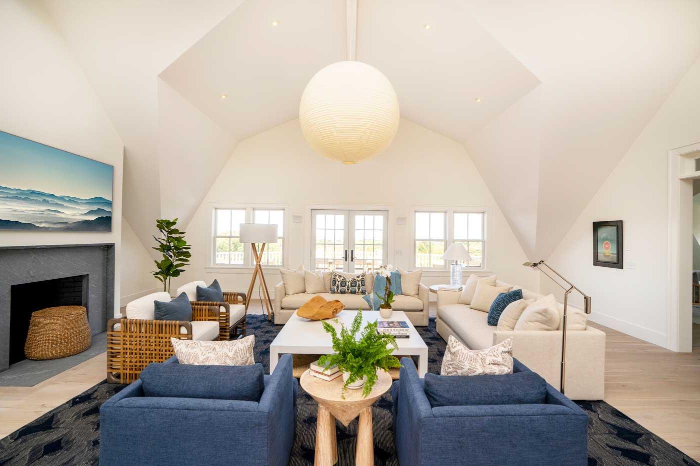 family room with off white sofas blue chairs and cathedral ceiling